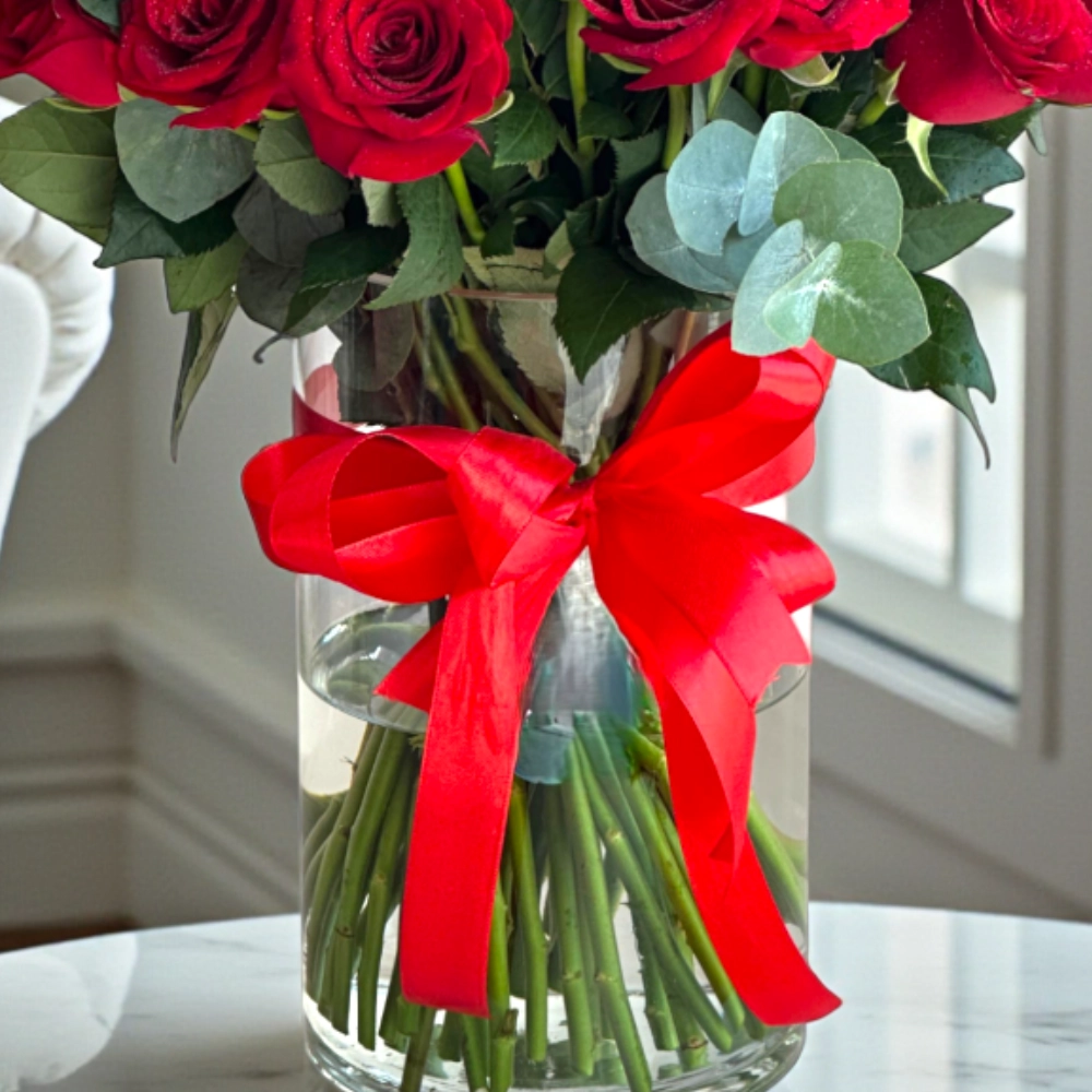 Bunch of 51 red rose with fillers in a glass vase
