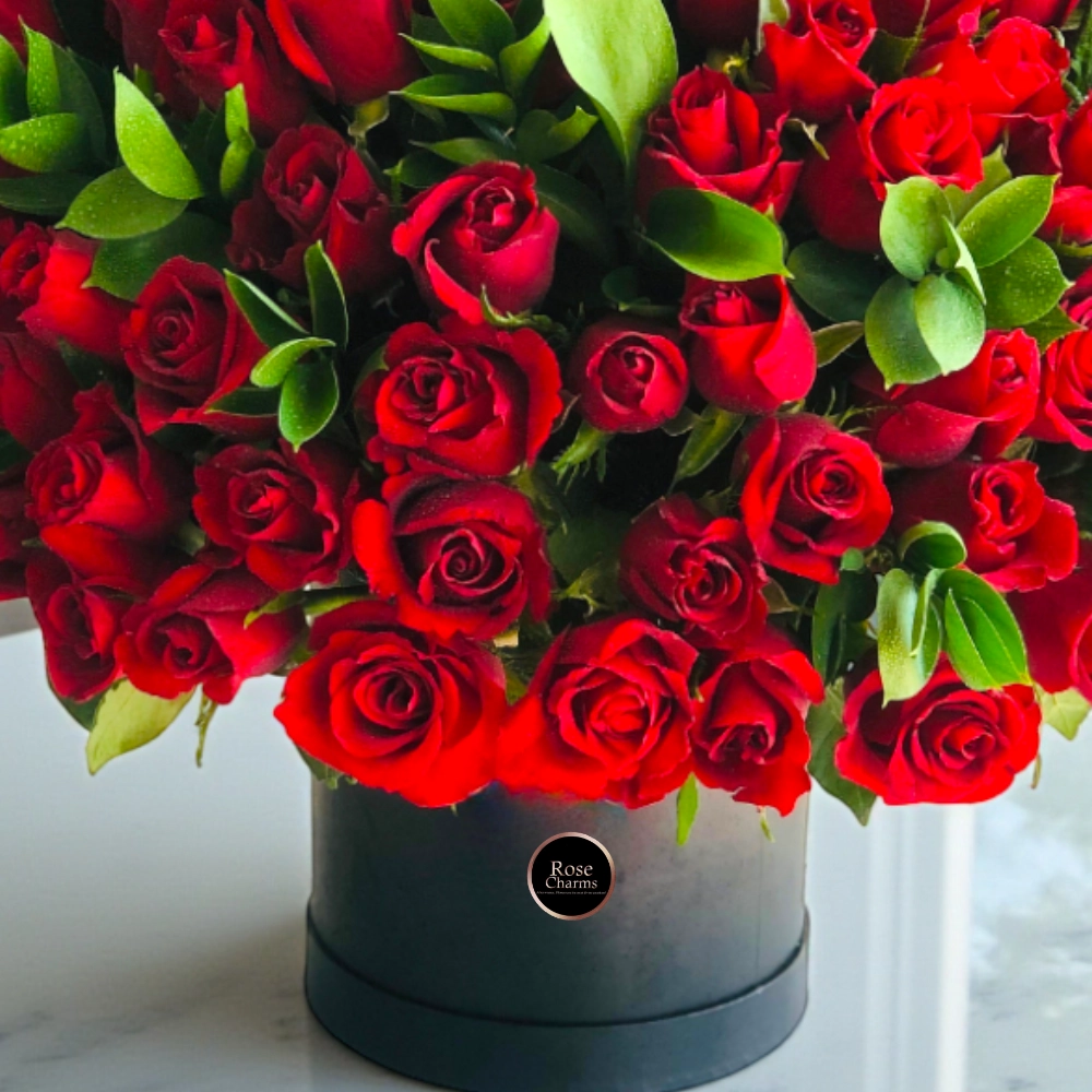 Arrangement of 100 red roses in a black box