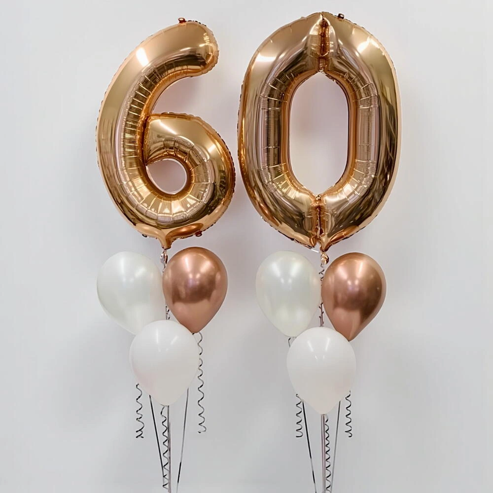Gold number 60 foil balloons with six white latex balloons for 60th birthday parties, anniversaries, and milestone celebrations