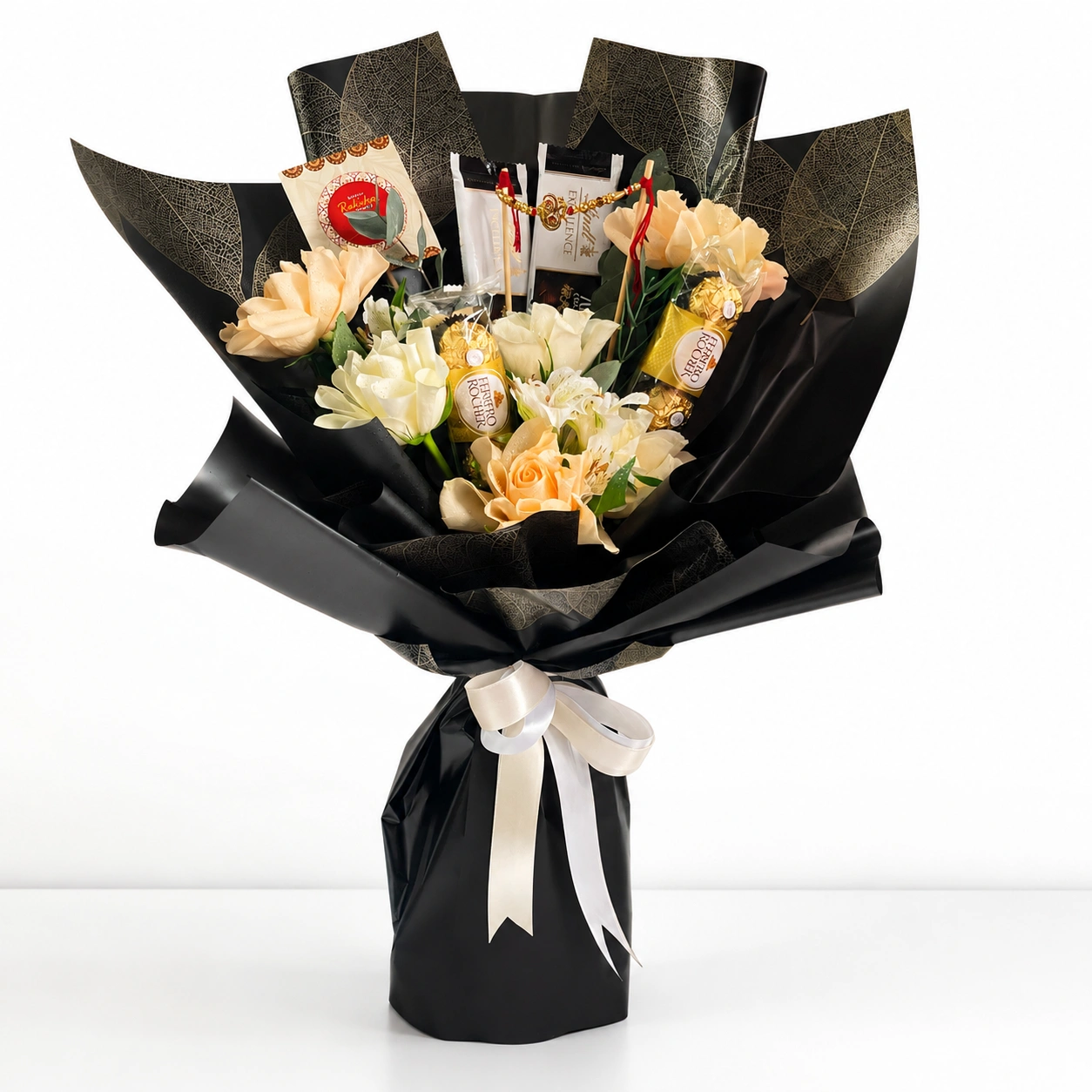 Elegant Rakhi Bloom & Chocolate Bouquet Hamper with peach roses, white roses, Ferrero Rocher chocolates, Lindt bars and Rakhi